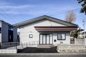 浜松市中央区領家町の公民館の外観写真です。 青空を背景に玄関を正面から写しています。